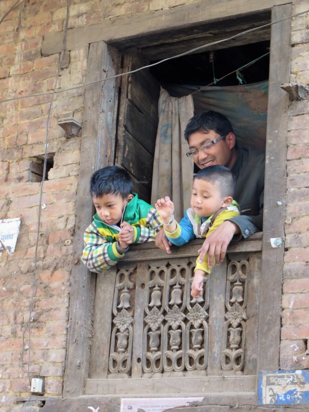 These guys were having a great time talking to their neighbors from their upstairs window.  Note the carvings on their shutters.
