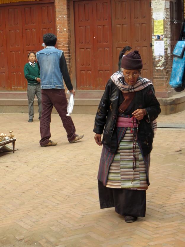 o boudha - tibetan lady heading to stoupa