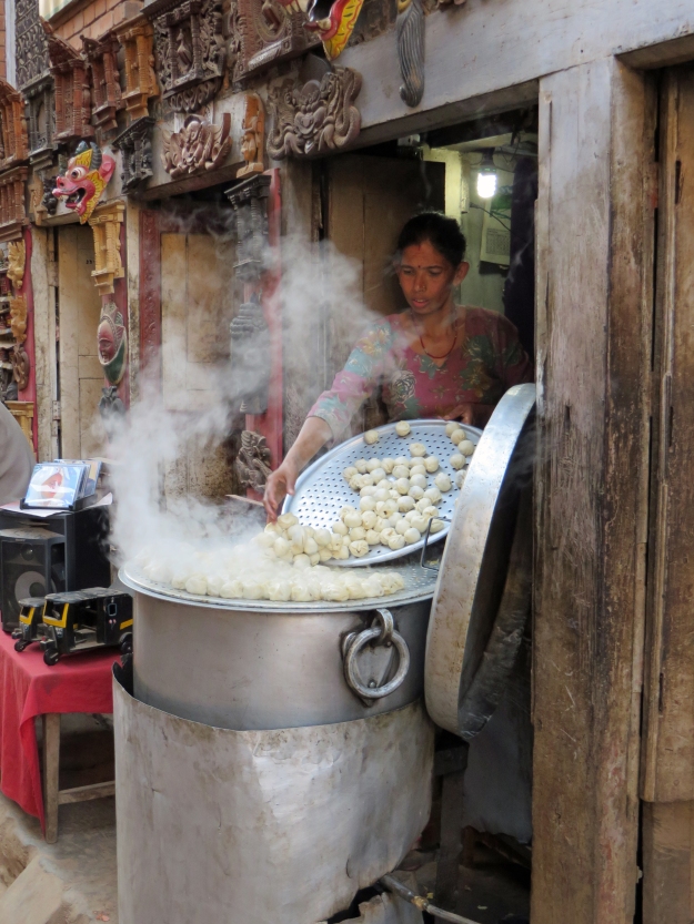 A great big pot of mono cooking in a steamer set out in the street.