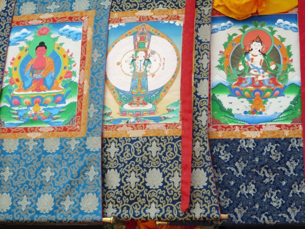 Thangkas are intricate paintings on cotton or silk that can take months to make.  They may depict the Buddha or a Buddhist deity, like those shown above.  Some tell a story (like the popular Life of the Buddha) or a teaching (like the Wheel of Life, one of my favorites) and others contain mandalas.  Beautiful works of art in their own right, they have been used for centuries as teaching and meditation tools.
