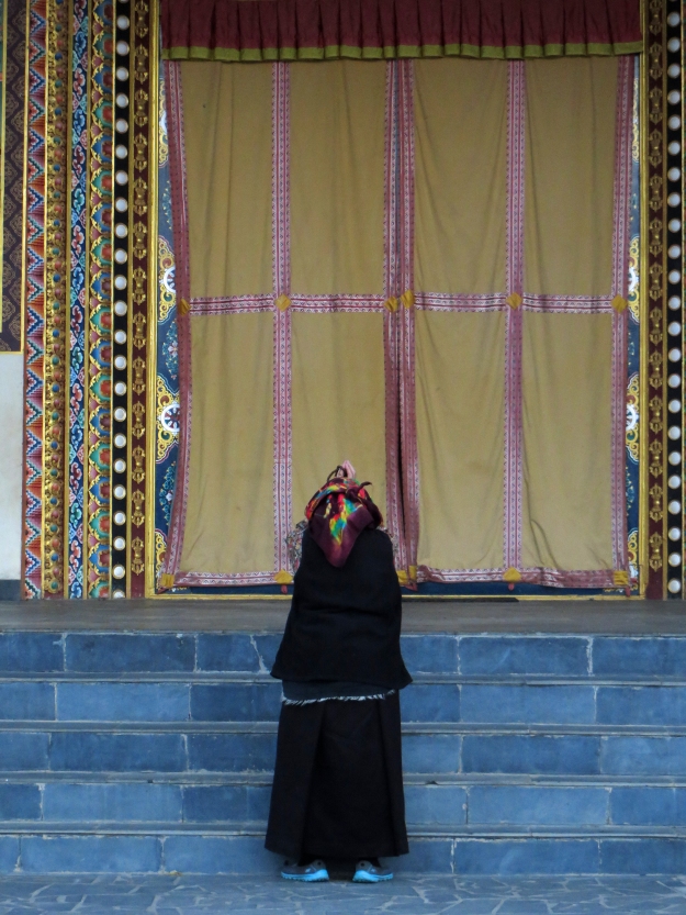 She looked so beautiful standing on the path to the temple (above photo) that I couldn't resist following her.  I snapped this photo as she prostrated herself at the temple's main door.