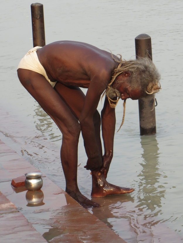 old sadhu bathing closer up